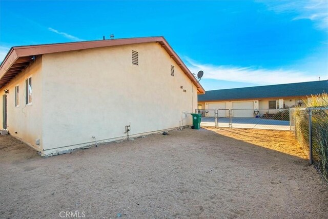 60803 Division St, Joshua Tree, CA 92252 - view of property exterior with stucco siding and a detached garage