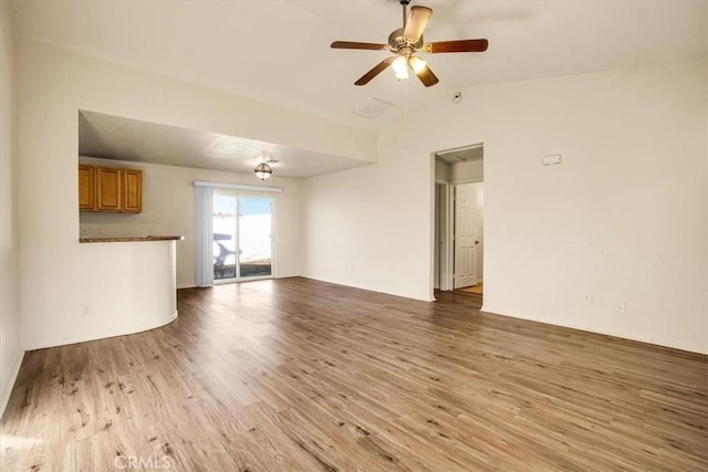 unfurnished living room featuring light wood-style floors, ceiling fan, and lofted ceiling