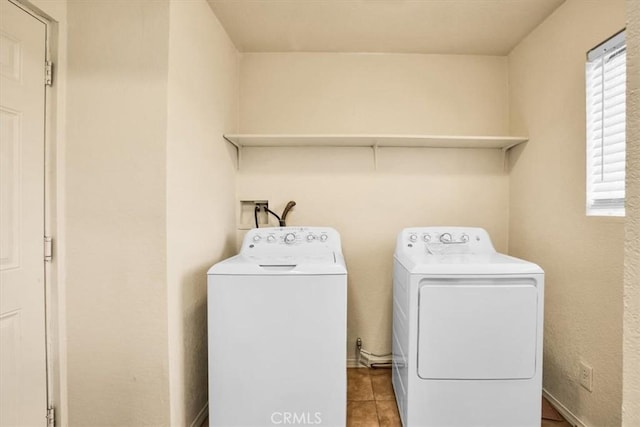 laundry area with tile patterned floors, laundry area, and washing machine and dryer
