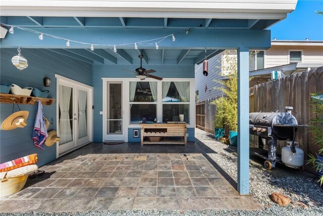 view of patio / terrace featuring a ceiling fan, fence, french doors, and a grill