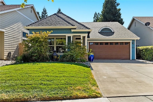 view of front facade featuring concrete driveway, an attached garage, roof with shingles, and a front lawn