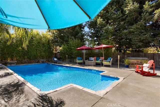 view of pool featuring a patio, a fenced backyard, a hot tub, and a fenced in pool