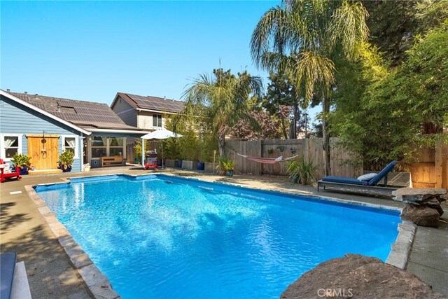 view of pool with a fenced in pool, a patio, and a fenced backyard