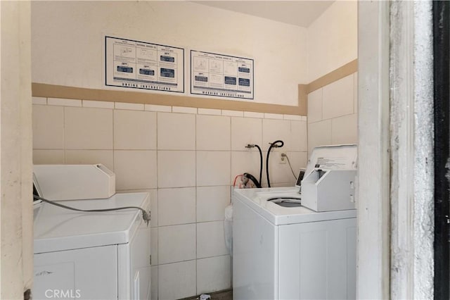 laundry area with washer / dryer, tile walls, and laundry area