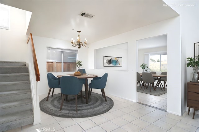 dining area featuring visible vents, an inviting chandelier, stairs, light tile patterned flooring, and baseboards