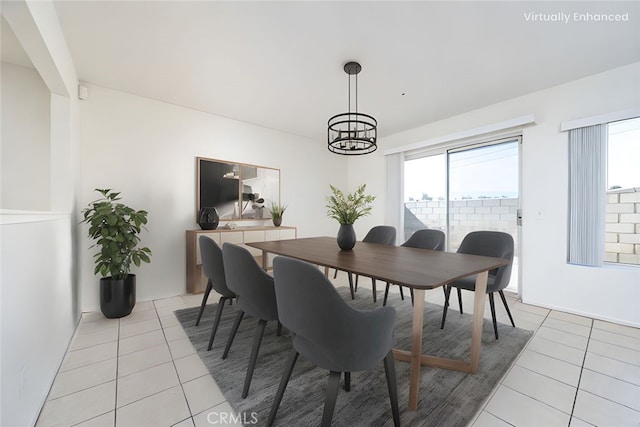 dining area with light tile patterned flooring and a chandelier