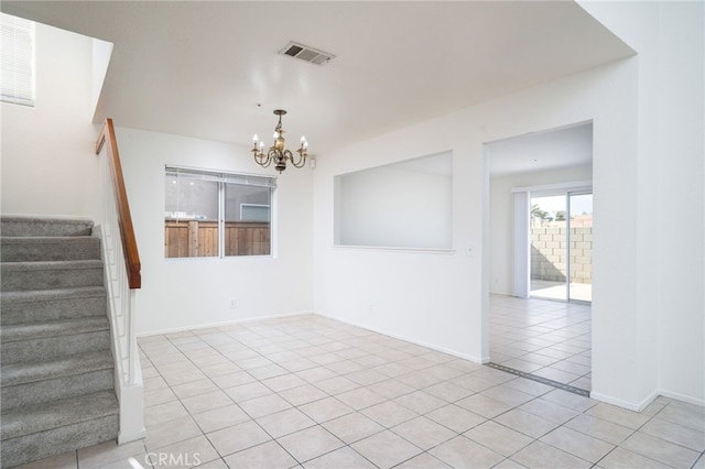 empty room with light tile patterned flooring, a chandelier, stairs, baseboards, and visible vents