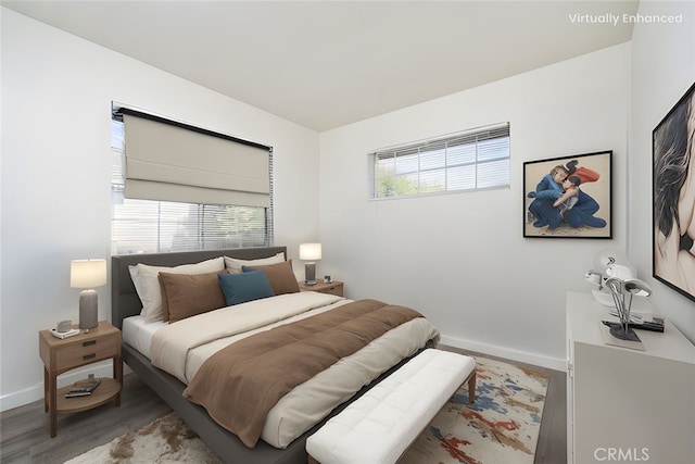 bedroom with baseboards and wood finished floors