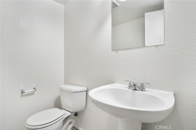 bathroom with visible vents, a sink, and toilet