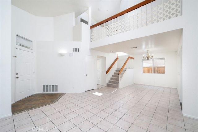 unfurnished living room with visible vents, stairs, light tile patterned floors, and an inviting chandelier