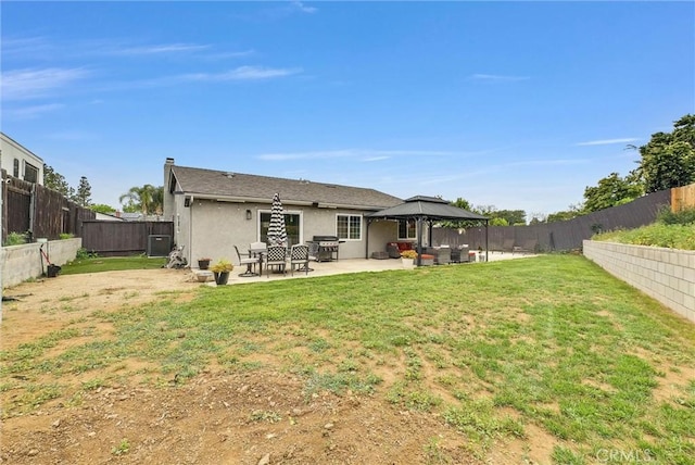 back of property with a gazebo, a patio, stucco siding, and an outdoor living space
