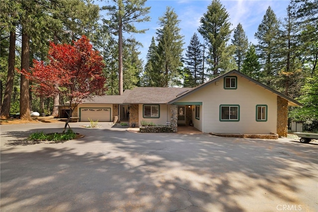 ranch-style home with an attached garage and driveway