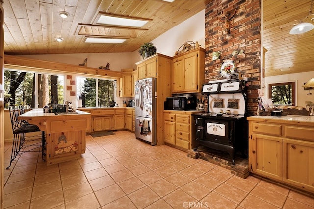 kitchen featuring wooden ceiling, tile countertops, and stainless steel fridge