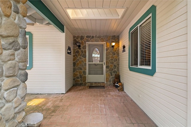 entrance to property featuring stone siding