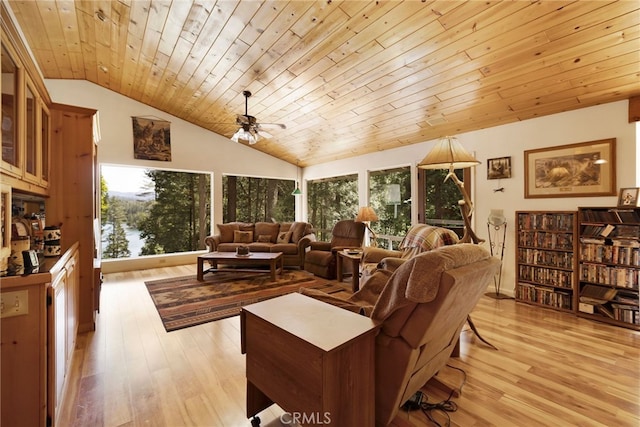 living room with a healthy amount of sunlight, light wood-style flooring, and lofted ceiling