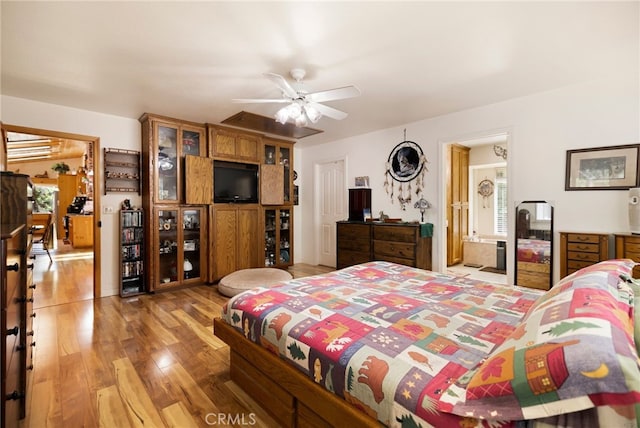 bedroom featuring multiple windows, a ceiling fan, and light wood finished floors
