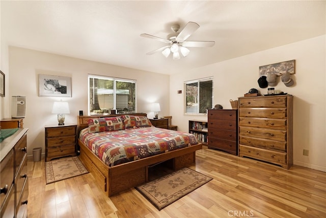 bedroom featuring baseboards, ceiling fan, and light wood-style flooring