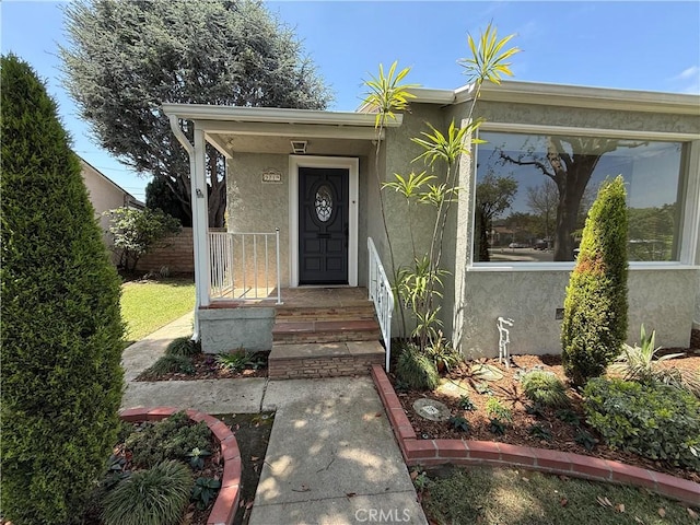 doorway to property with stucco siding