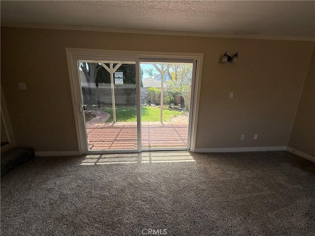 interior space featuring crown molding, baseboards, and carpet flooring