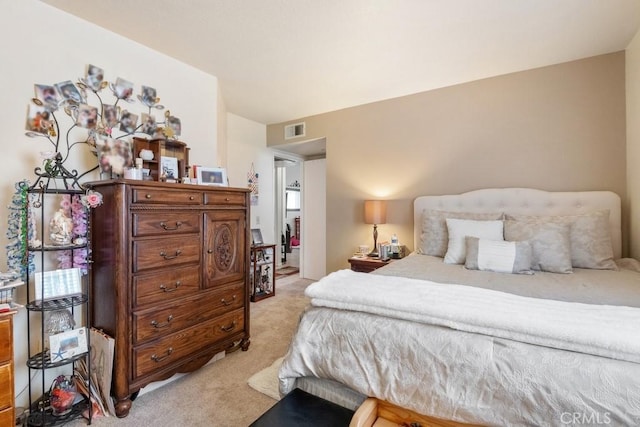 bedroom featuring light carpet and visible vents