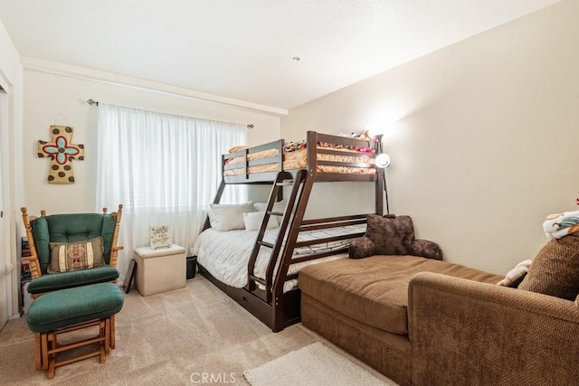 bedroom featuring light carpet