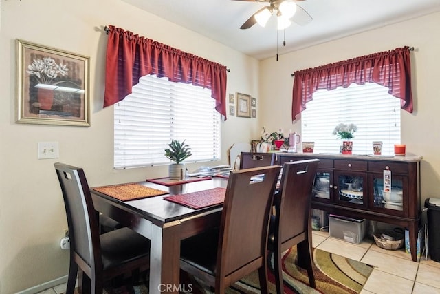 dining space featuring ceiling fan and tile patterned floors