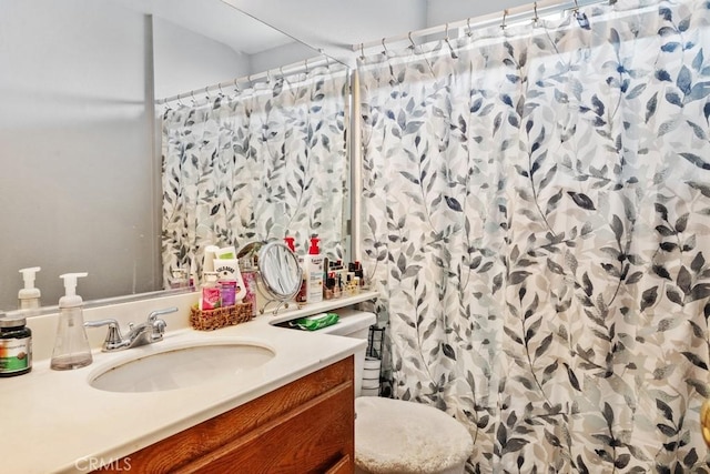 bathroom featuring vanity, toilet, and a shower with shower curtain
