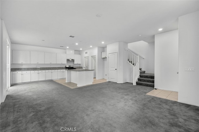 2017 Juniper Ln, Colton, CA 92324 - unfurnished living room featuring recessed lighting, visible vents, light tile patterned flooring, stairway, and light colored carpet