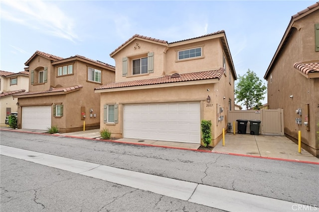 2017 Juniper Ln, Colton, CA 92324 - view of front of property featuring a tiled roof, stucco siding, fence, and a garage