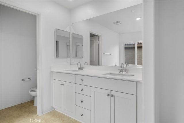 2017 Juniper Ln, Colton, CA 92324 - full bathroom featuring double vanity, toilet, baseboards, and a sink