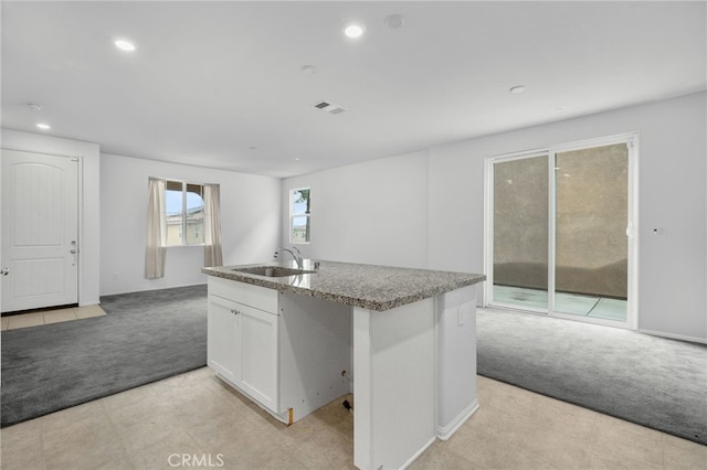 2017 Juniper Ln, Colton, CA 92324 - kitchen featuring recessed lighting, visible vents, a sink, white cabinets, and light colored carpet
