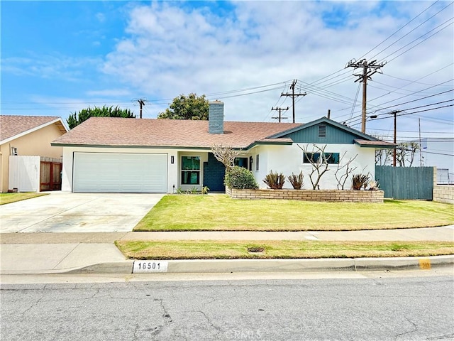 ranch-style house with fence, an attached garage, concrete driveway, and a front yard