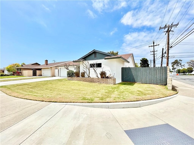 view of front of home featuring fence, an attached garage, a front lawn, stucco siding, and concrete driveway