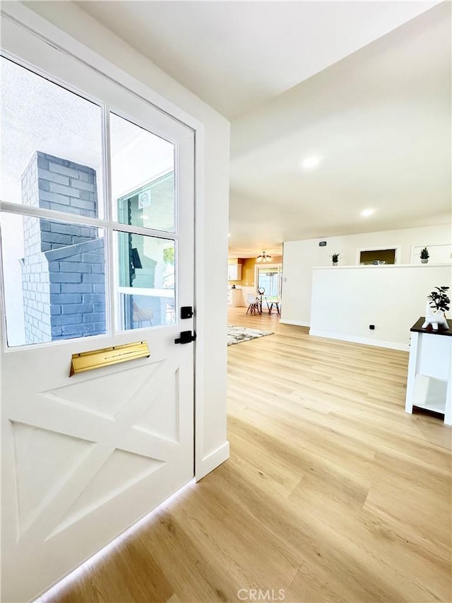 entryway with baseboards and light wood-type flooring