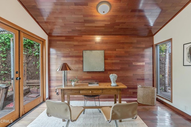 office with wooden walls, wood ceiling, vaulted ceiling, and wood finished floors