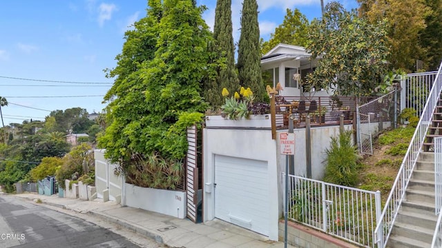 view of front of property with a garage and stairs