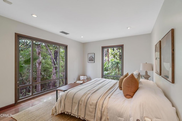 bedroom featuring recessed lighting, visible vents, and wood finished floors