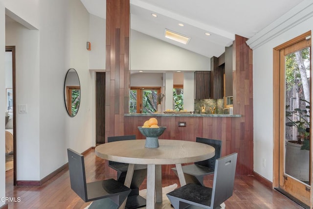 dining space featuring baseboards, recessed lighting, wood finished floors, and lofted ceiling