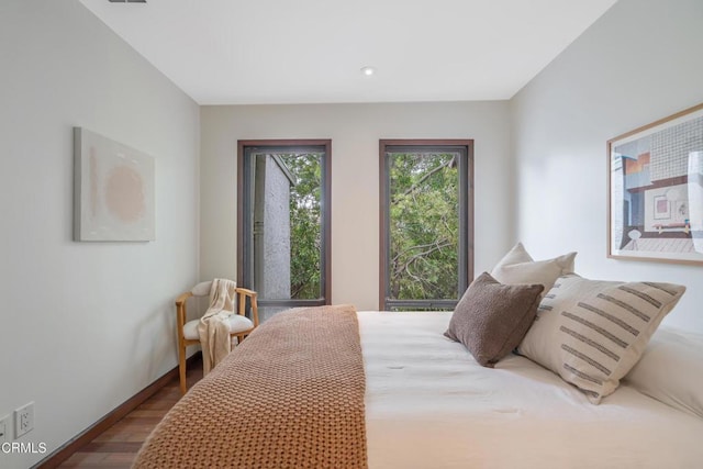 bedroom with baseboards, recessed lighting, and wood finished floors