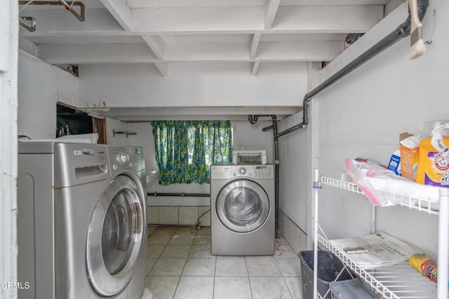 washroom featuring separate washer and dryer and laundry area