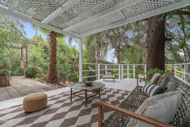 view of patio featuring a wooden deck, a pergola, and an outdoor hangout area