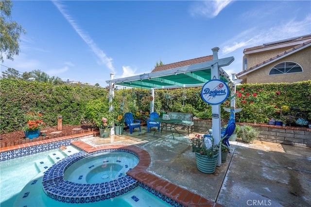 view of pool featuring a pool with connected hot tub and a patio area