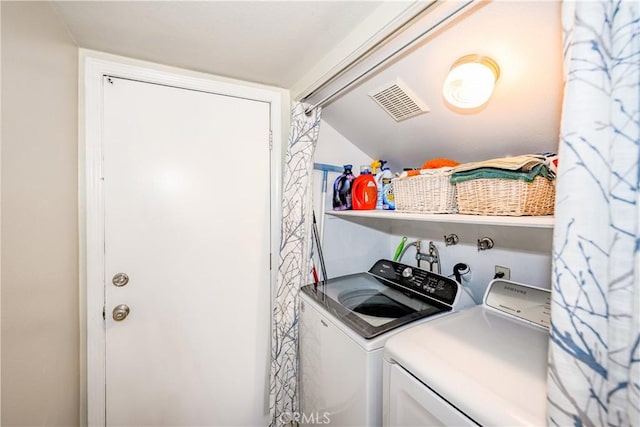 laundry area with visible vents, laundry area, and washing machine and clothes dryer