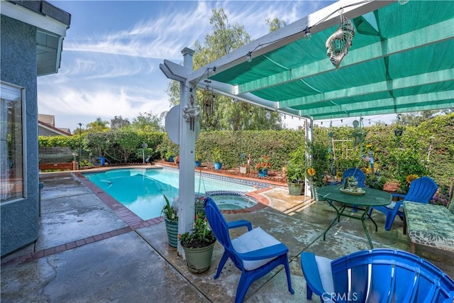 pool with a patio, a fenced backyard, and an in ground hot tub