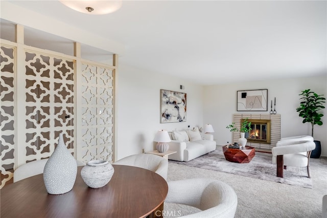 living area with carpet flooring and a fireplace