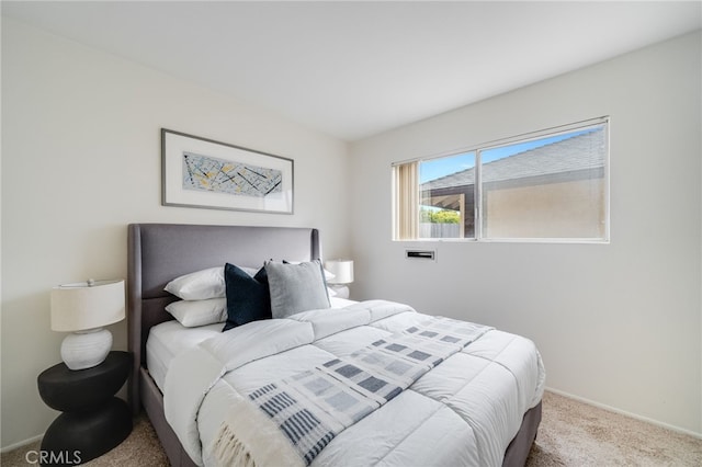 bedroom featuring baseboards and carpet
