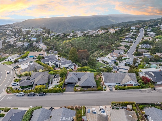 aerial view at dusk with a mountain view and a residential view