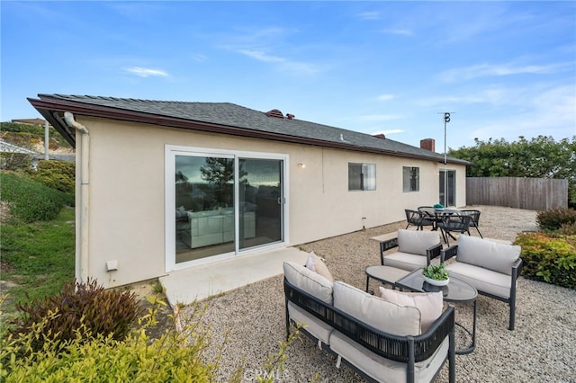 back of house with fence, outdoor dining space, an outdoor hangout area, stucco siding, and a patio