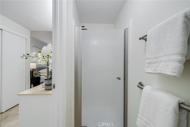 bathroom with tile patterned floors and a shower stall