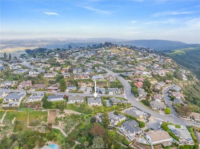 drone / aerial view featuring a residential view and a mountain view